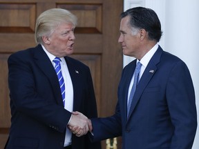 In this Nov. 19, 2016, file photo, President-elect Donald Trump and Mitt Romney shake hands as Romney leaves the Trump National Golf Club Bedminster in Bedminster, N.J. (AP Photo/Carolyn Kaster, File)