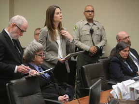 Attorneys standing David Macher, left, and Allison Lowe, appear with their clients David, second left, and Louise Turpin, second right, appear in court for a conference about their case in Riverside, Calif., Friday, Feb. 23, 2018. (Watchara Phomicinda/The Press-Enterprise via AP, Pool)