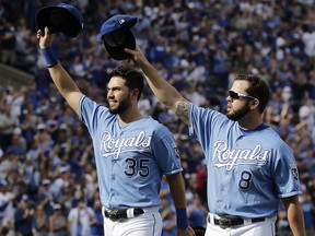 In this Oct. 1, 2017, file photo, Kansas City Royals Eric Hosmer (35) and Mike Moustakas (8) acknowledge the crowd during a game against the Arizona Diamondbacks, in Kansas City, Mo. (AP Photo/Charlie Riedel, File)