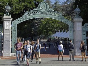 In this April 21, 2017, file photo, students walk past Sather Gate on the University of California, Berkeley campus in Berkeley, Calif.