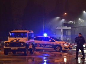 Police block off the area around the U.S. Embassy in Montenegro's capital Podgorica, Thursday, Feb. 22, 2018. Local media say that an unknown assailant hurled a hand grenade toward the embassy at around midnight local time (1100 GMT) and then killed himself with another explosive device. (AP Photo/Risto Bozovic)