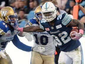 Toronto Argonauts running back James Wilder Jr. (32) runs the ball against Winnipeg Blue Bombers linebacker Jovan Santos-Knox (45) in Toronto on Saturday, October 21, 2017. (THE CANADIAN PRESS/Nathan Denette)