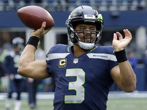 Seattle Seahawks quarterback Russell Wilson passes during warmups before a game against the Los Angeles Rams, Sunday, Dec. 17, 2017, in Seattle. (AP Photo/Elaine Thompson)