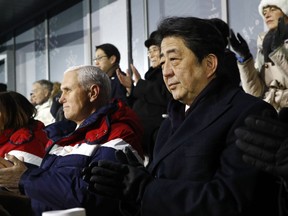 In this Feb. 9, 2018, file photo, Japanese Prime Minister Shinzo Abe, right, sits alongside Vice President Mike Pence, centre, and second lady Karen Pence at the opening ceremony of the 2018 Winter Olympics in Pyeongchang, South Korea, Friday, Feb. 9, 2018.
