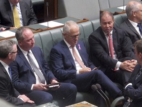 Australian Deputy Prime Minster Barnaby Joyce, second from left, sits with colleagues including Prime Minister Malcolm Turnbull, center, during a session in the Australian Parliament in Canberra, Thursday, Feb. 15, 2018.