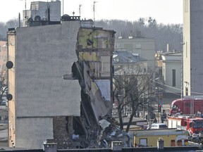 Rescuers work at a collapsed building  in Poznan, Poland, Sunday, March 4, 2018. An apartment block collapsed Sunday in Poland's western city of Poznan, killing several people and injuring more than 20 others, officials said as teams of firefighters and rescuers with dogs combed the rubble in search of more victims.