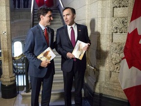 Prime Minister Justin Trudeau, left, speaks with Minister of Finance Bill Morneau as he arrives to table the budget in Ottawa in a March 22, 2016.