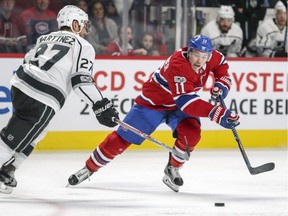 Montreal Canadiens' Brendan Gallagher pushes the puck past Los Angeles Kings' Alec Martinez in Montreal on Oct. 26, 2017.