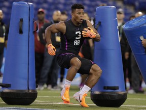 Penn State running back Saquon Barkley runs a drill at the NFL football scouting combine last week. (AP PHOTO)