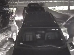 This screenshot of a video released by the Royal Newfoundland Constabulary shows a pair of vandals smashing a truck's windows in St. John's, N.L.