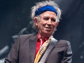 British musician Keith Richards of the Rolling Stones performs on the Pyramid Stage on the fourth day of the Glastonbury Festival of Contemporary Performing Arts near Glastonbury, southwest England, in this June 29, 2013 file photo. (ANDREW COWIE/AFP/Getty Images)
