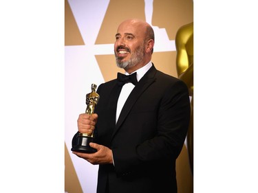 Costume designer Mark Bridges, winner of the Best Costume Design award for 'Phantom Thread,' poses in the press room during the 90th Annual Academy Awards at Hollywood & Highland Center on March 4, 2018 in Hollywood, California.