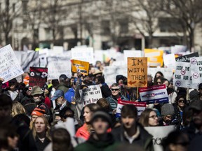 Demonstrators hold signs at the start of the March for Our Lives rally March 24, 2018 in Washington, DC.