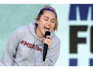 Miley Cyrus performs "The Climb" during the March for Our Lives rally on March 24, 2018 in Washington, DC. Hundreds of thousands of demonstrators, including students, teachers and parents gathered in Washington for the anti-gun violence rally organized by survivors of the Marjory Stoneman Douglas High School shooting on February 14 that left 17 dead. More than 800 related events are taking place around the world to call for legislative action to address school safety and gun violence.