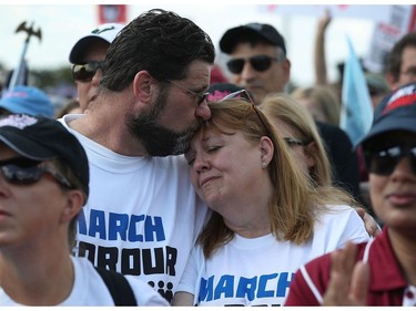 Chris Lehman and his wife Sandra Lehman hug  as they participate in the March For Our Lives event at Pine Trails Park before walking to Marjory Stoneman Douglas High School on March 24, 2018 in Parkland, Florida. The event was one of many scheduled around the United States calling for gun control after a gunman killed 17 people on February 14 at the high school.