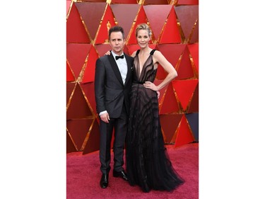 US actor Sam Rockwell (L) and his wife US actress Leslie Bibb arrive for the 90th Annual Academy Awards on March 4, 2018, in Hollywood, California.