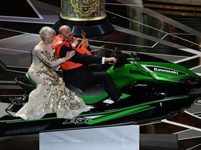 British actress Helen Mirren (L) rides with jet ski winner and laureate for Costume Design Mark Bridges after the Oscar ceremony host offered a jet ski to the Oscars winner with the shortest speech during the 90th Annual Academy Awards show on March 4, 2018 in Hollywood, California.