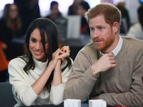Britain's Prince Harry (R) and fiancee US actress Meghan Markle (L) attend an event hosted by social enterprise Stemettes to celebrate International Women's Day at Millennium Point in Birmingham on March 8, 2018. Prince Harry and Meghan Markle visited Birmingham to learn more about the work of two projects which support young people from the local community. The event at Millennium Point aims to inspire the next generation of young women to pursue careers in Science, Technology, Engineering and Maths (STEM).