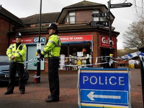 Police officers stand on duty at a cordon near a bench covered in a protective tent at The Maltings shopping centre in Salisbury, southern England, on March 12, 2018, where a man and woman were found critically ill on March 4, after being apparently poisoned with what was later identified as a nerve agent sparking a major incident.