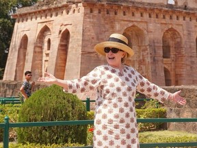 Former US politician Hillary Clinton gestures outside the remains of the Hindola Mahal monument, part of an abandoned royal palace complex, while on a personal trip to the ancient city of Mandu in India's Madhya Pradesh state on March 12, 2018.