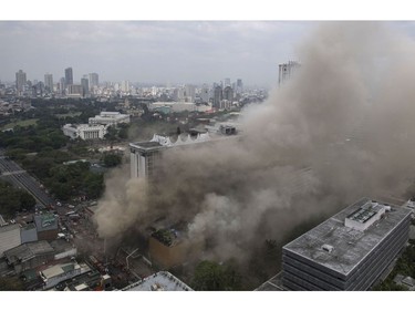 Heavy smoke engulfs the Waterfront Manila Pavilion building, after a fire broke out at the hotel and casino complex in Manila on March 18, 2018. (TED ALJIBE/AFP/Getty Images)