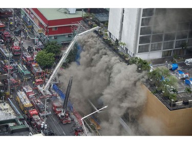 Heavy smoke covers several floors of the Waterfront Manila Pavilion building, after a fire broke out the hotel and casino complex in Manila on March 18, 2018. (TED ALJIBE/AFP/Getty Images)