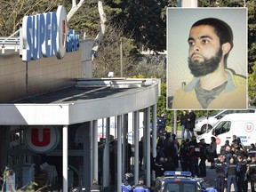 French security and police gather outside the Super U supermarket in the town of Trebes, southern France, where authorities say Radouane Lakdim (also pictured) took hostages killing at least three before he was killed by security forces on March 23, 2018.  PASCAL PAVANI/AFP/Getty Images