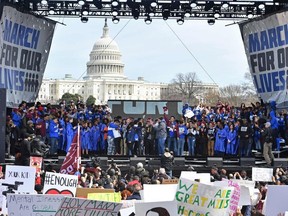 Students gather on stage during the March for Our Lives Rally in Washington, DC on March 24, 2018.