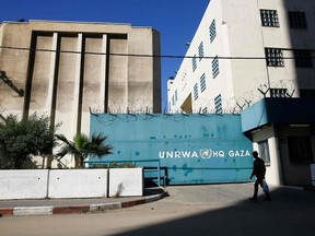 A Palestinian man walks past the building of the UNRWA headquarters in Gaza City on January 8, 2018.