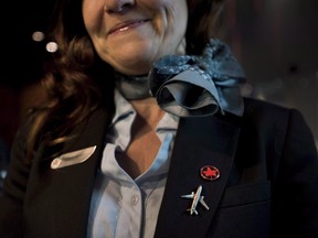The union representing Air Canada flight attendants says it has filed a human rights complaint alleging "systemic discrimination and harassment" of flight attendants." A flight attendant smiles while posing at Air Canada's annual general meeting in Toronto on Tuesday, May 12, 2015. THE CANADIAN PRESS/Darren Calabrese