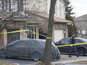 Durham Regional Police at the scene on Hilling Dr. in Ajax after one person was found dead and another rushed to hospital on Wednesday, March 14, 2018.