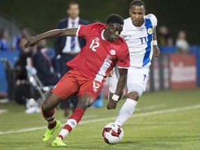 Canada's Alphonso Davies, front, clears the ball away from Curacao's Gevaro Nepomuceno during the second half of an international friendly soccer match in Montreal on June 13, 2017.