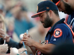 Houston Astros second baseman Jose Altuve signs autographs for fans before a spring training baseball game against the St. Louis Cardinals on March 9, 2018