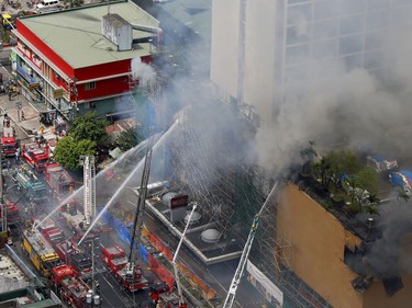 Firemen battle a fire that engulfs the Manila Pavilion Hotel and Casino Sunday, March 18, 2018 in Manila, Philippines.  (AP Photo/Bullit Marquez)