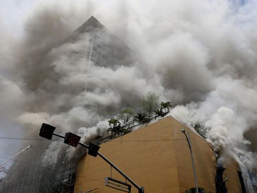 A fire engulfs the Manila Pavilion Hotel and Casino Sunday, March 18, 2018 in Manila, Philippines. (AP Photo/Bullit Marquez)
