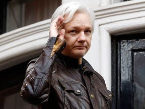 In this May 19, 2017 file photo, WikiLeaks founder Julian Assange greets supporters from a balcony of the Ecuadorian embassy in London. (AP Photo/Frank Augstein, File)