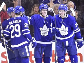 Maple Leafs centre Auston Matthews (34) celebrates with defenceman Jake Gardiner (51), centre Zach Hyman (11) and centre William Nylander (29) after scoring against the Panthers during first period NHL action in Toronto on Wednesday, March 28, 2018.