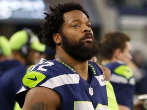 In this Dec. 24, 2017, file photo, Seattle Seahawks defensive end Michael Bennett watches his team play the Dallas Cowboys in Arlington, Texas. (AP Photo/Michael Ainsworth, File)