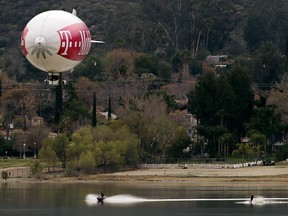 A blimp tows waterskiers on Lake Elsinore, Calif., on Tuesday, March 13, 2018.    (Terry Pierson/Los Angeles Daily News via AP)