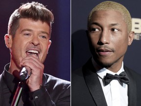In this combination photo, Robin Thicke performs at the Teen Choice Awards in Los Angeles on Aug. 16, 2015, left, and Pharrell Williams attends the 2016 ABFF Awards: A Celebration of Hollywood in Beverly Hills, Calif., on  Feb. 21, 2016. (Matt Sayles/Invision/AP, File)