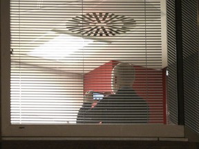 Information Commissioner's Office enforcement officers work inside the offices of Cambridge Analytica in central London after a High Court judge granted a search warrant, Friday March 23, 2018.  (Yui Mok/PA via AP)