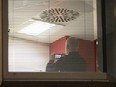 Information Commissioner's Office enforcement officers work inside the offices of Cambridge Analytica in central London after a High Court judge granted a search warrant, Friday March 23, 2018.  (Yui Mok/PA via AP)