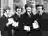 In this Oct. 26, 1965 file photo The Beatles, from left: Ringo Starr, John Lennon, Paul McCartney and George Harrison smile as they display the Member of The Order of The British Empire medals presented to them by Queen Elizabeth II in a ceremony in Buckingham Palace in London, England. (AP Photo, File)