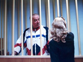 In this Wednesday, Aug. 9, 2006 file photo, Sergei Skripal speaks to his lawyer from behind bars seen on a screen of a monitor outside a courtroom in Moscow.