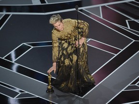 Frances McDormand places her award for best performance by an actress in a leading role for "Three Billboards Outside Ebbing, Missouri" on the stage at the Oscars on Sunday, March 4, 2018, at the Dolby Theatre in Los Angeles.  (Chris Pizzello/Invision/AP)