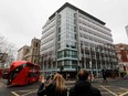 Pedestrians cross the road near outside the shared building which houses the offices of Cambridge Analytica in central London on March 24, 2018. (TOLGA AKMEN/AFP/Getty Images)