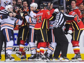 The Calgary Flames mix it up after the whistle with the Edmonton Oilers during an NHL game at Scotiabank Saddledome on March 13, 2018