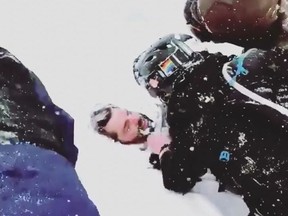 In this screenshot, rescuers scramble to dig out Evan Huck after an avalanche.