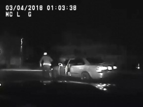 In this screenshot, 30-year-old Isaac Bonsu is seen running next to his car on police dashcam footage.
