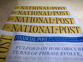 Copies of the Postmedia-owned newspaper National Post are displayed at a hotel in Burnaby, B.C., on Tuesday, January 19, 2016. Torstar Corp. and Postmedia Network Inc. have signed a deal that will see the companies swap a number of community and daily newsapers. THE CANADIAN PRESS/Darryl Dyck